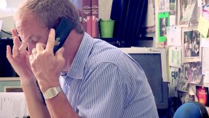 Directeur haar zijn bureau aan het bellen