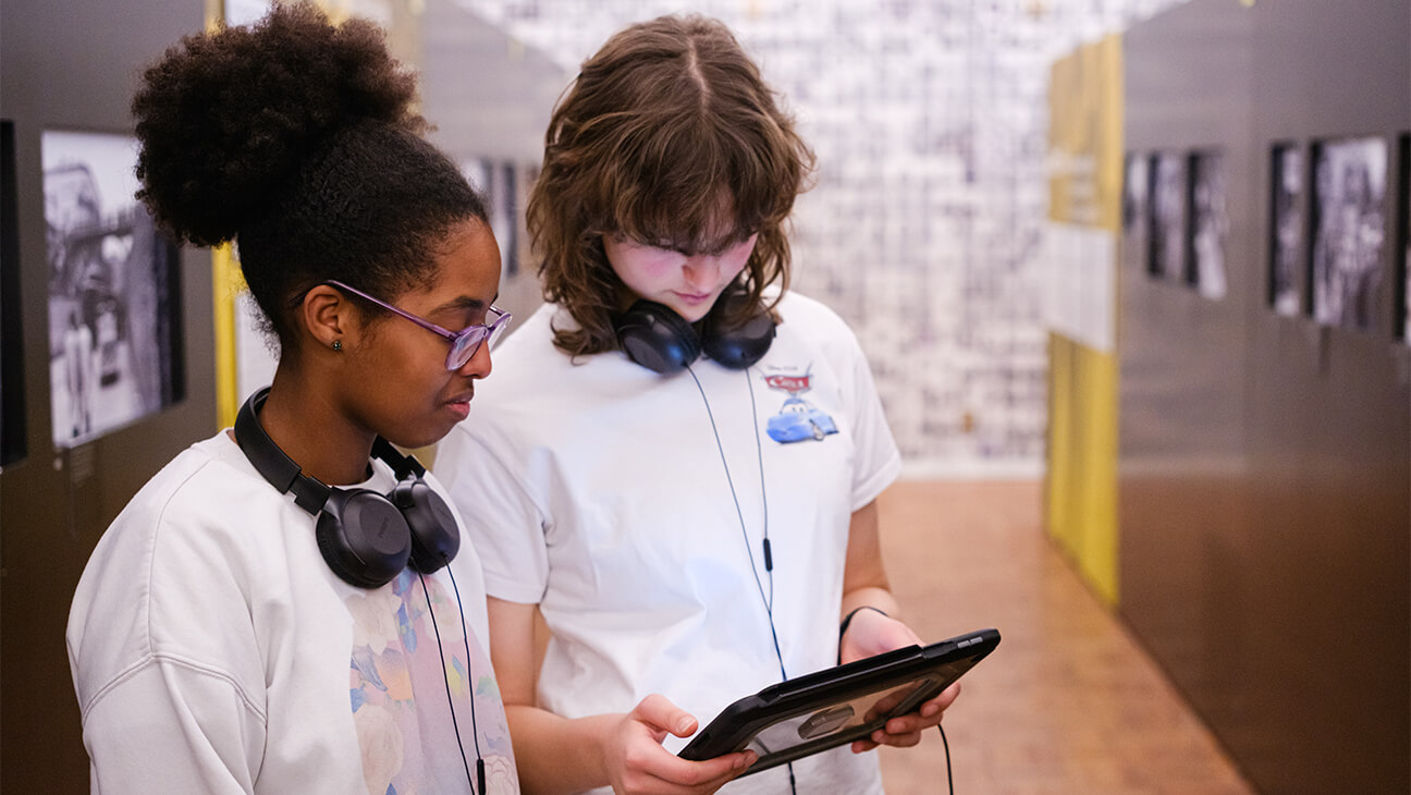 Bezoekers met een tablet in Kazerne Dossin