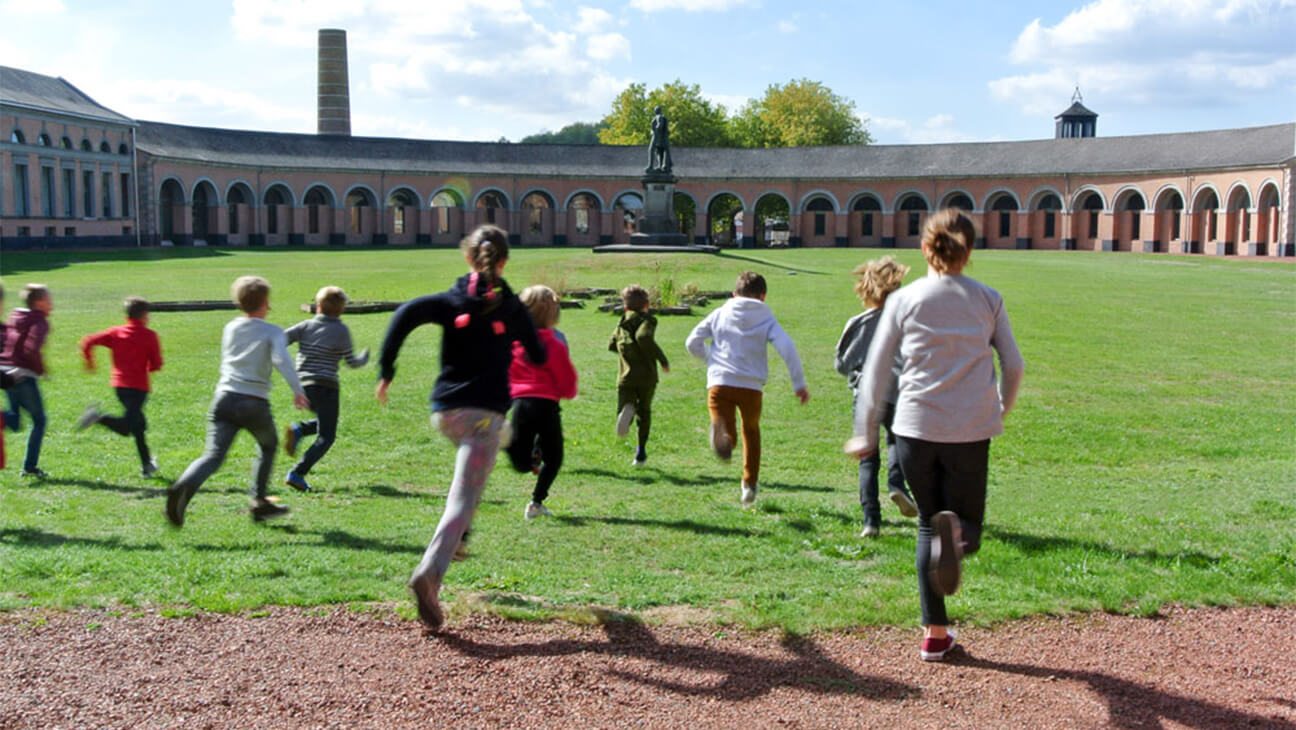 Kinderen lopen buiten in et Musée des Arts Contemporains