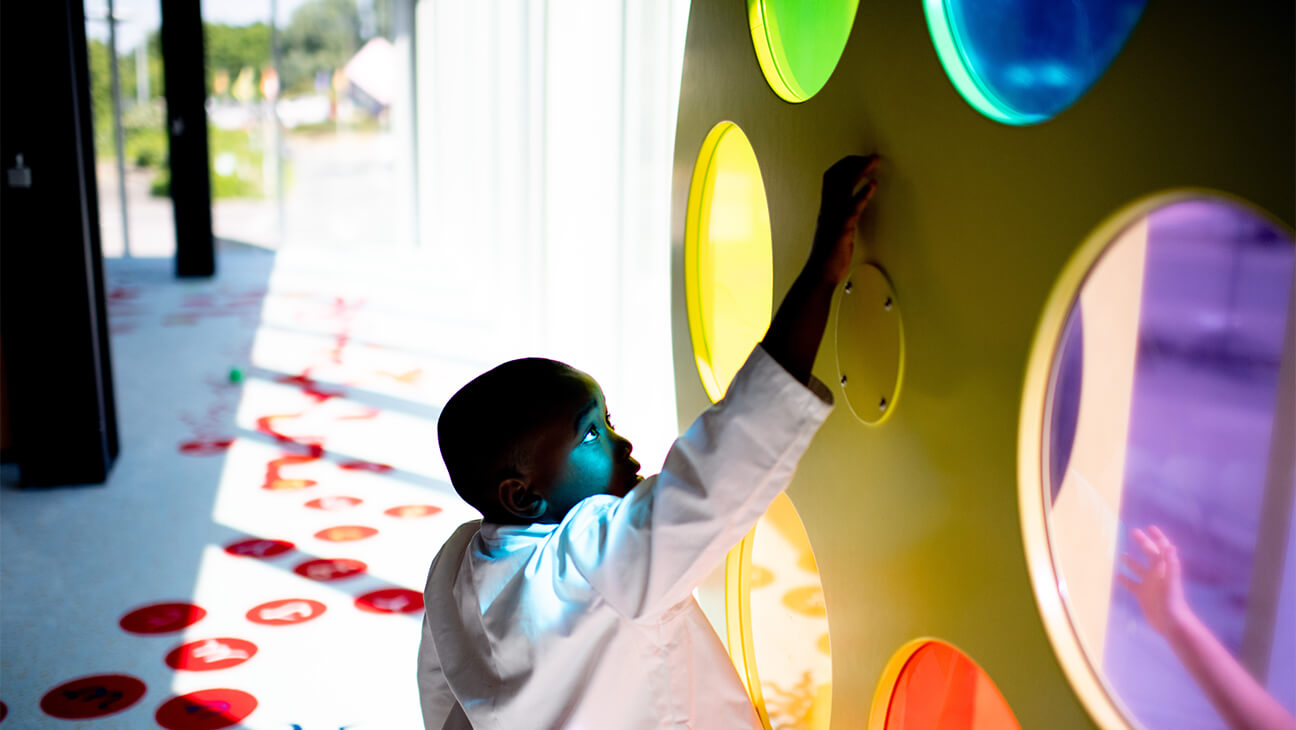 Jongen bij gekleurde bollen in Technopolis