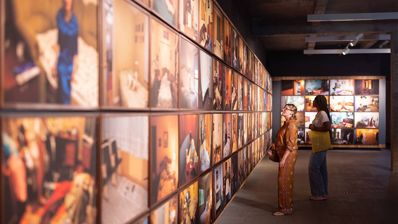 Vrouw voor een muur vol foto's van Bieke Depoorter